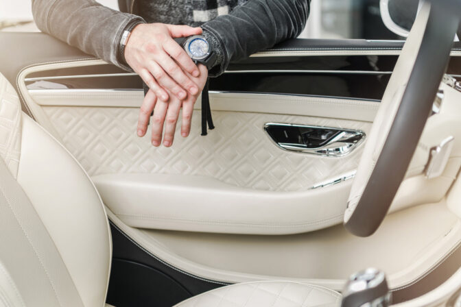 luxury car interior with man s hands and watch limousine